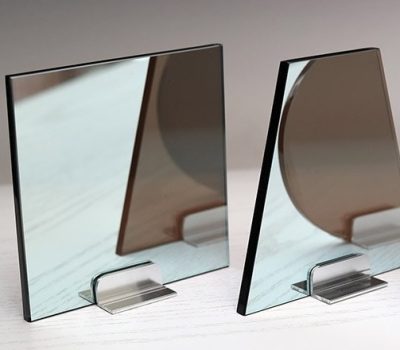 Front and Back side Glass Two Way Mirror Sample in three different shapes. Testing the reflectivity and the light transmission through the mirror. Standard two way mirror has a seventy percent reflection with an eleven percent light transmission on a dark bronze substrate. Perfect for Smart Mirrors, security applications, mirror tv's and more.